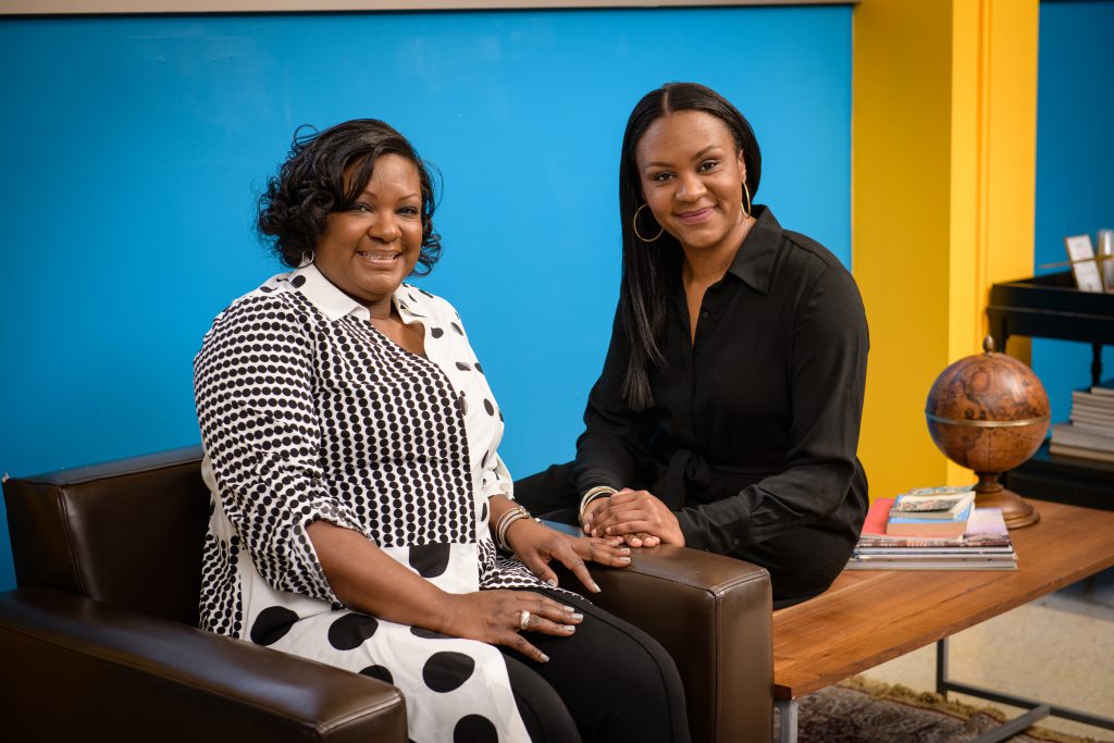 Two black female entrepreneurs pose for the camera